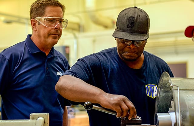 Manufacturing Academy instructor teaches student machining