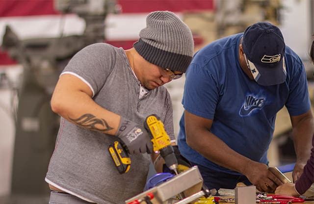 Manufacturing Academy pre-apprenticeship students use power tools in class