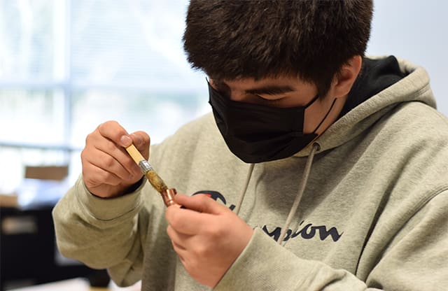 Truman High School pre-apprenticeship student preparing copper pipe