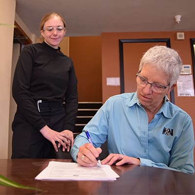 Apprentice watches as her employer signs her up for apprenticeship