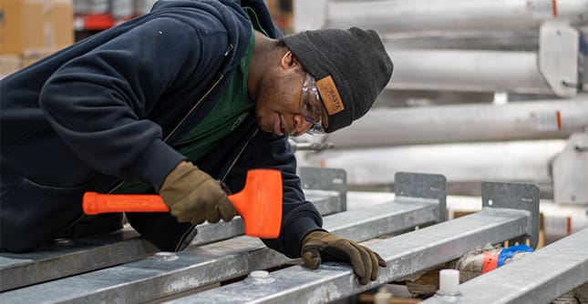 Luke preps final assembly of a boatlift during work at Basta Boatlifts.