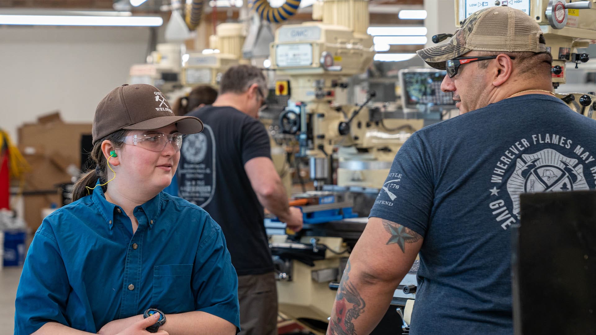 An instructor at South Puget Sound Community College talks with a machining student in the Operation Next program.