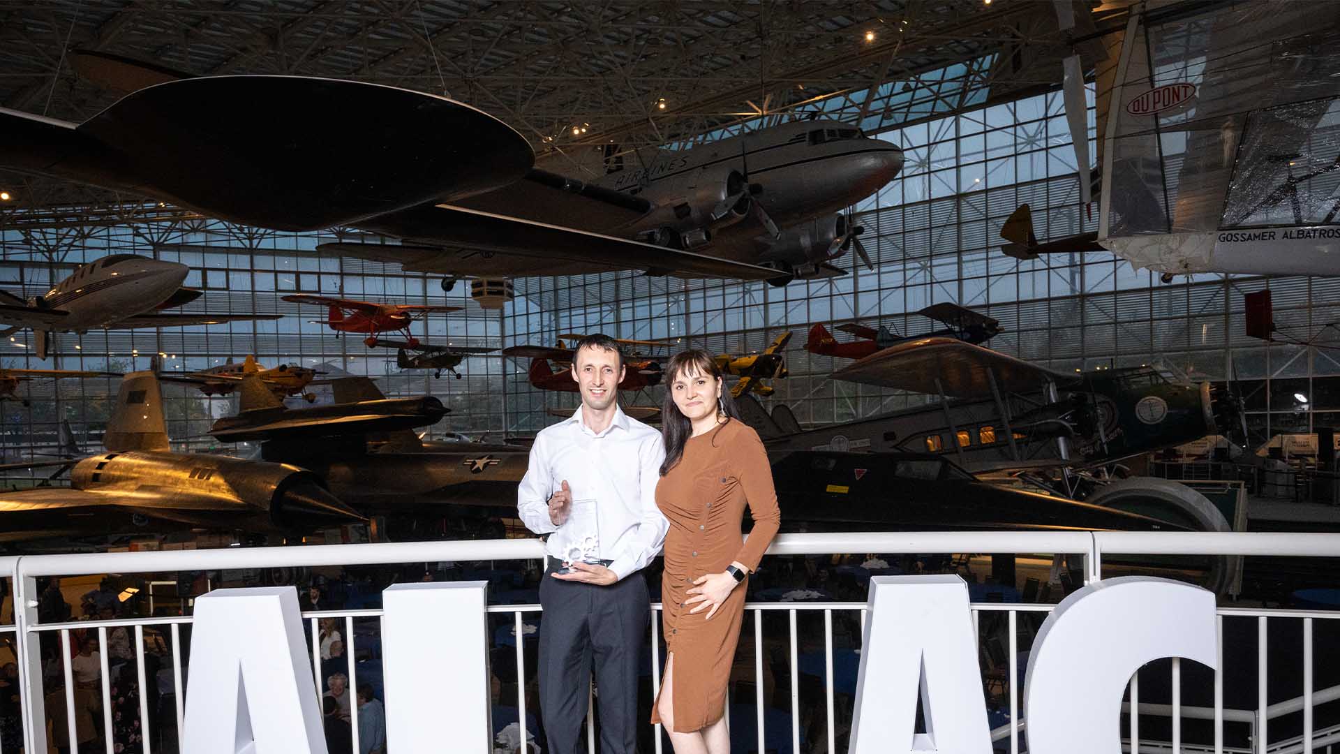 Sergiu and his wife pose for a photo after the conclusion of AJAC's 2023 apprenticeship graduation at the Museum of Flight.