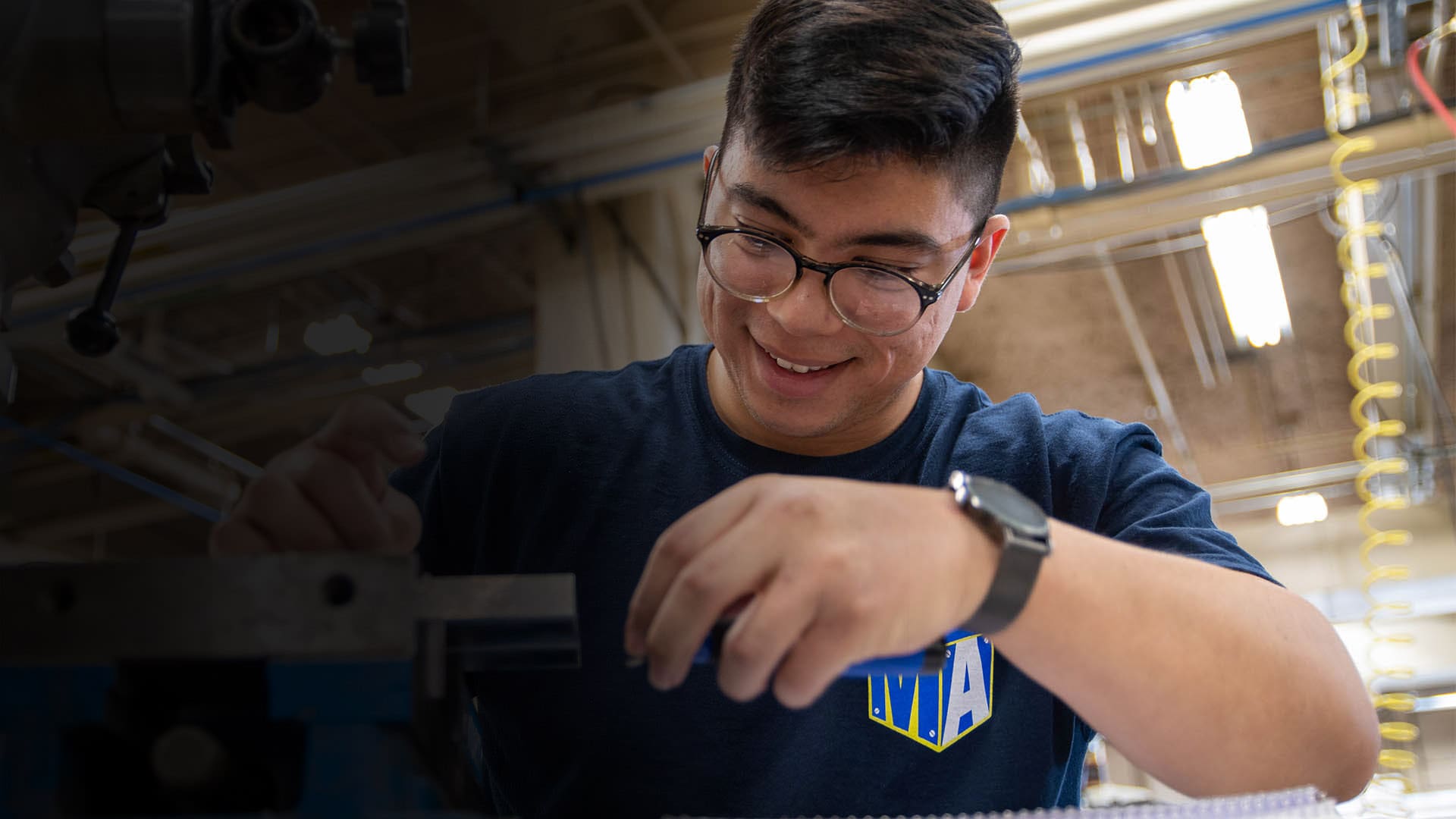 A Manufacturing Academy student uses a manual mill during class at Bates Technical College.