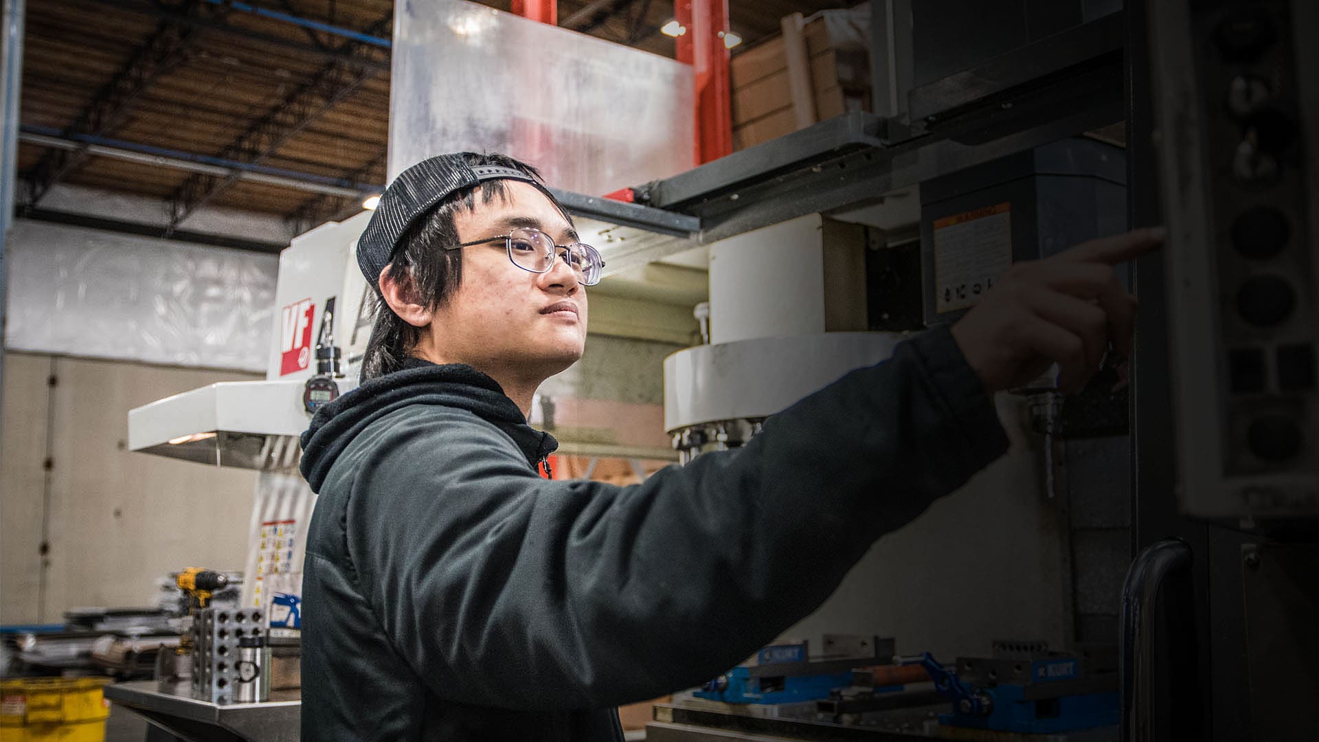 An AJAC Youth Apprentice operates a HAAS VF4 mill during his on-the-job training at American Structures and Design.