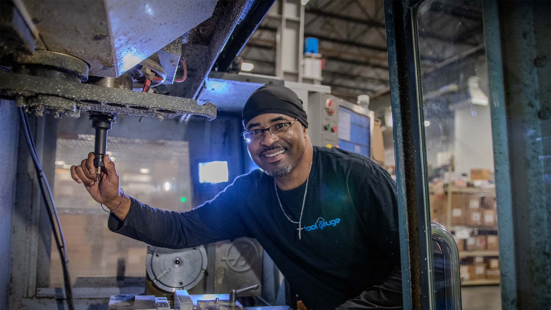 Adolphus Redding inside a HAAS VF2 during his shift as a machinist apprentice at Tool Gauge in Tacoma, Washington.