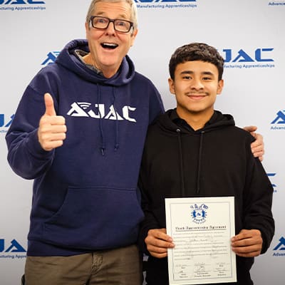 Creed Tremain-Nelson pauses for a photo with an AJAC Youth Apprentice during Genie Industries' Signing Day Ceremony.