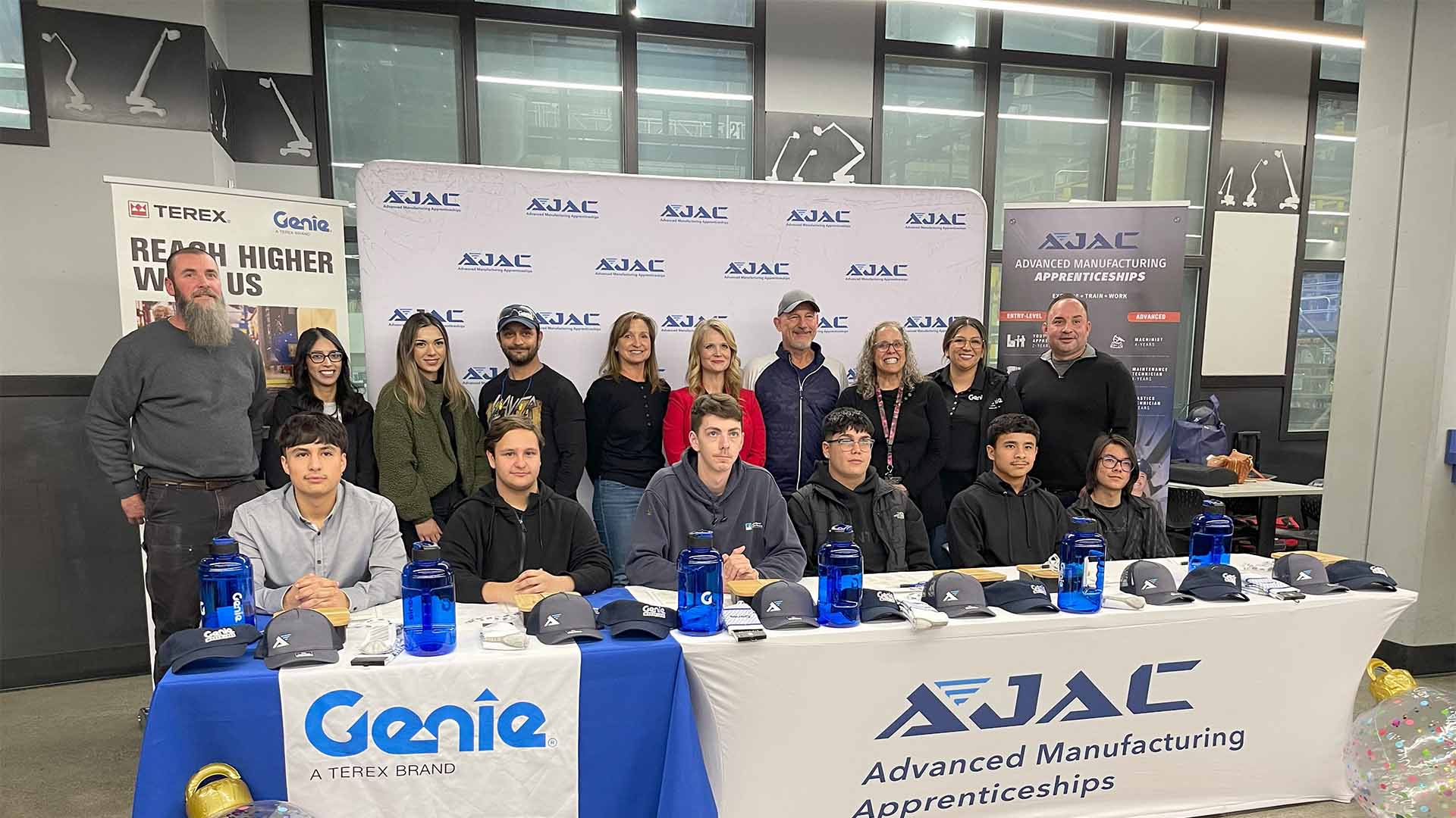 AJAC Youth Apprentices take a photo with representatives from Genie Industries during Genie's Youth Apprenticeship Signing Day in December 2023