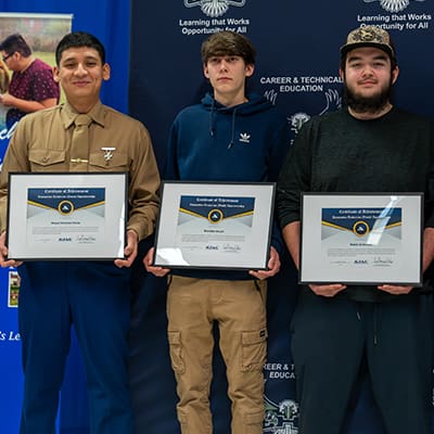 Elma Youth Apprentices from the first cohort pause for a photo with their new AJAC plaques.