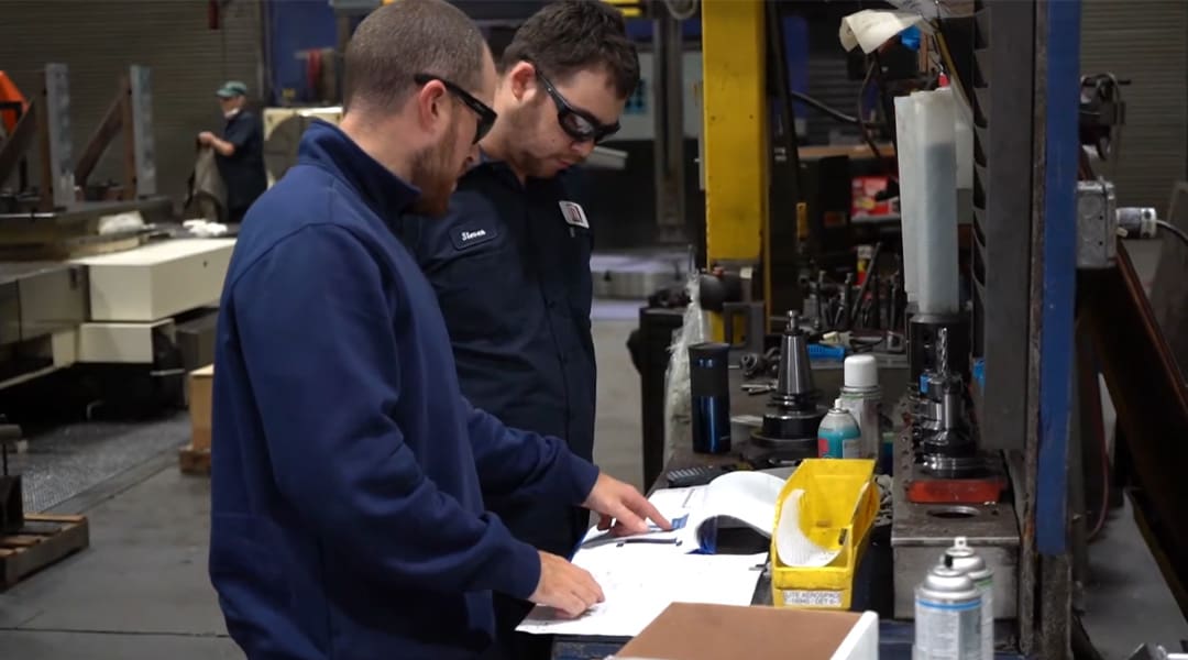 Apprentices learn on the job during their AJAC machinist apprenticeship program.