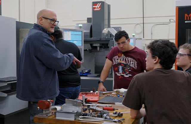 Two AJAC instructors teach apprentices during an evening class at Renton Technical College.