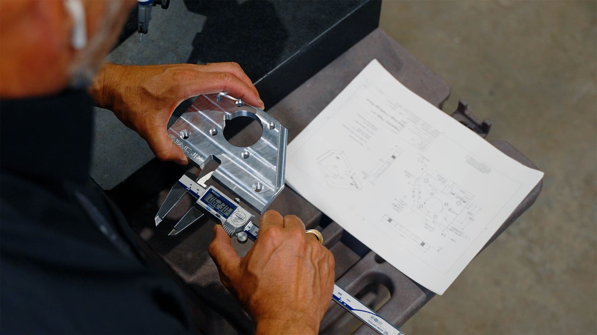 A machinist uses GD&T training to inspect a part.