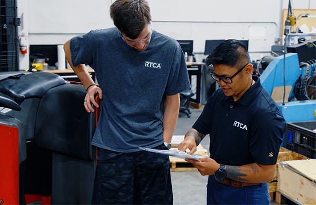Leana works with a staff member in the shipping department at RTCA in Fife, Washington.