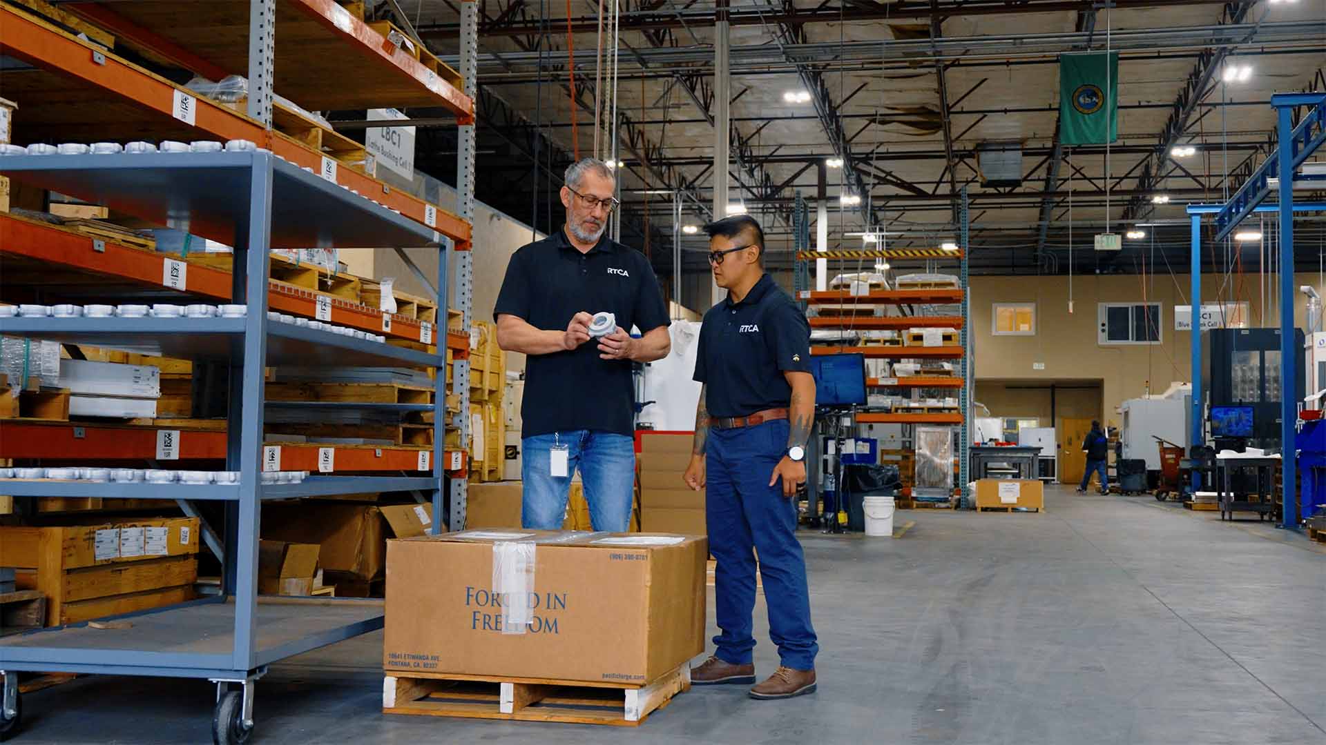 Leana and her supervisor walk the shop floor in the shipping department at RTCA in Fife, Washington.